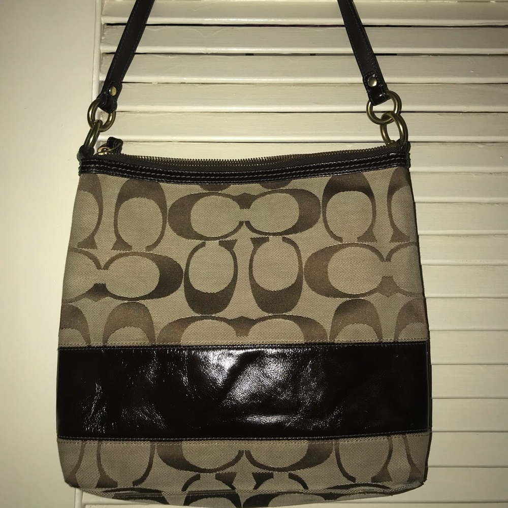Coach purse brown with leather band on the bag